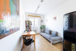 a living room with a couch and a tv at Penziony Beneš in Prague