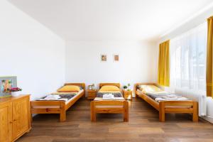 a hospital room with three beds and a window at Penziony Beneš in Prague