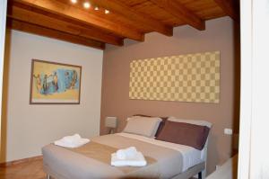 a bedroom with a bed with two towels on it at Poncinvs Residence in Zanica