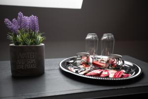 a tray of food and a vase with purple flowers at Urban 7 Residence in Bucharest