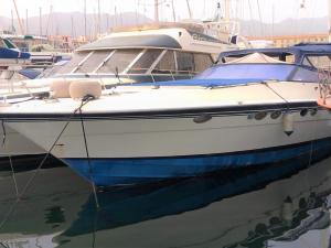 a white boat is docked in a harbor at Desirè Charming House Boat in Palermo