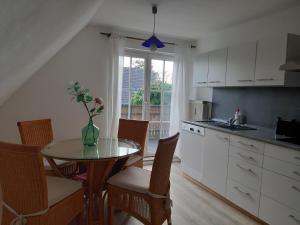 una cocina con una mesa con un jarrón de flores. en Bassener Monteurwohnung, en Oyten