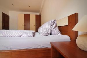a bedroom with two beds and a desk with a lamp at Apartmán Romantika Chopok Juh 12 in Tale