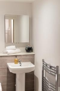 a bathroom with a sink and a mirror at Open Key Apartments in Liverpool