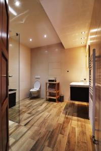 a bathroom with a toilet and a sink and a tub at Apartmán Romantika Chopok Juh 12 in Tale
