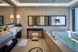 
a bathroom with a large mirror and a large tub at Galaxy Macau in Macau
