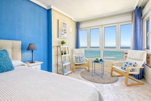 a bedroom with a bed and two chairs at SPECTACULAR VIEWS PENTHOUSE IN 1ST LINE BEACH in Torrox Costa +38 photos