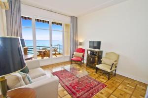 a living room with a view of the ocean at BEACHSIDE SUITE PANORAMIC - PROMENADE HOLIDAY in Nice