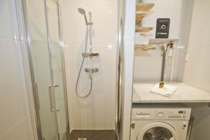 a bathroom with a shower and a washing machine at BEACHSIDE SUITE PANORAMIC - PROMENADE HOLIDAY in Nice +23 photos