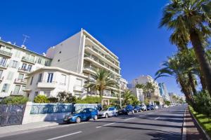 a street with cars parked on the side of a building at BEACHSIDE SUITE PANORAMIC - PROMENADE HOLIDAY in Nice