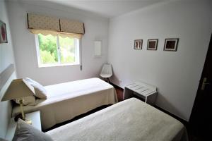 Postel nebo postele na pokoji v ubytování T1 Alvor/ Prainha