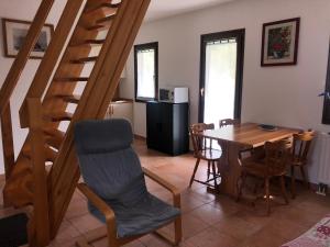 a kitchen and dining room with a staircase and a table at Vila Noblesa Apartmaji in Most na Soči