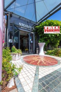 a store with a sign in front of a building at Hotel Stoiser Graz in Graz