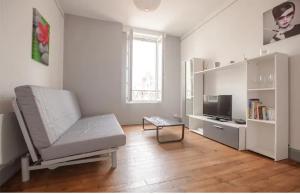 uma sala de estar branca com um sofá e uma televisão em Appartement charmant dans le centre de Biarritz Dan 3ème étage em Biarritz
