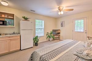 a bedroom with a white refrigerator and a kitchen at Cozy Studio with Yard, 6 Miles to Dwtn Beaufort! in Beaufort