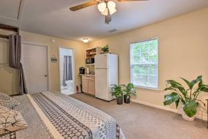 a bedroom with a bed and a white refrigerator at Cozy Studio with Yard, 6 Miles to Dwtn Beaufort! in Beaufort