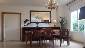 een eetkamer met een tafel en stoelen en een spiegel bij casa santa caterina in Torroella de Montgrí