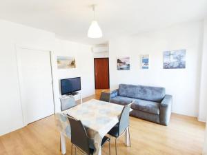 a living room with a table and a couch at Maredena in Lido di Jesolo