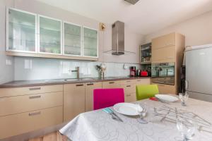 a kitchen with a table with chairs and a refrigerator at Les Terrasses du Palais in Vannes +3 photos