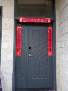 a black door with red signs on top of it at 一中太陽綠墅 in Taichung