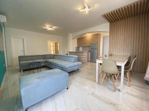 a living room with a blue couch and a table at B&T Apartments in Budva