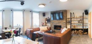 a living room with a couch and a fireplace at Smrcina Resort in Smrčina