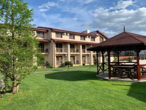 a large building with a gazebo in a yard at Hotel Astoria in Alba Iulia