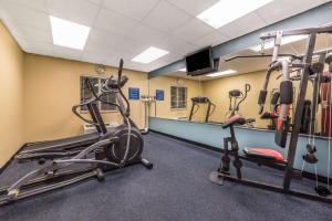 a gym with exercise bikes and a mirror at Days Inn by Wyndham Rockdale Texas in Rockdale