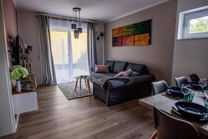 a living room with a couch and a table at Ferienwohnung TinyBeach in Lubmin