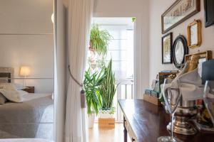 1 dormitorio con plantas, 1 cama y ventana en Orchidea Home, en Las Palmas de Gran Canaria