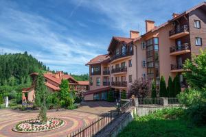 a large building with a garden in front of it at СПА-Готель "RESPECT" in Skhidnitsa