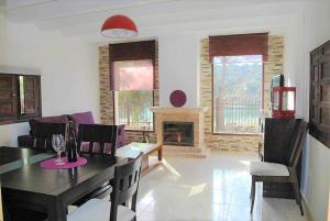 a living room with a dining table and a fireplace at Casa Rural Villa Sem Sem in Ossa de Montiel