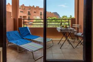 balkon z dwoma krzesłami i stołem na balkonie w obiekcie Apartamentos Sotavento - Playa La Tejita - El Médano w mieście El Médano