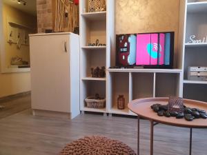 um quarto com um frigorífico, uma mesa e uma televisão em Stay Inn Plovdiv em Plovdiv