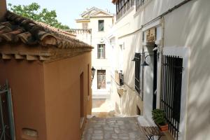 an alley in a town with white buildings at George Studio in Athens