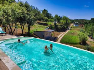 a group of people playing in a swimming pool at Uxa Paraiso in Penela