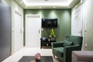 een woonkamer met groene muren en een groene stoel bij Luxurious Beach House, feels like home in Alexandroupoli