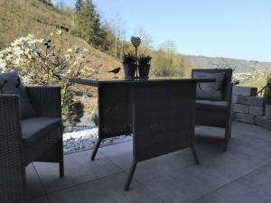 a table and chairs on a patio with a view at Kleines Moselchalet in Cochem