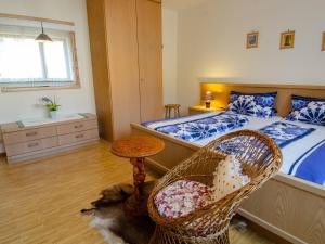 a bedroom with a large bed and a chair at Haus Harter in Wolfach