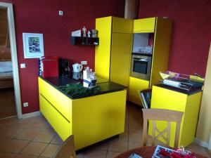 a lego kitchen with a yellow counter and a refrigerator at Blockhaus-Ferienwohnung in Oppenau
