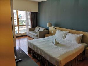 En eller flere senge i et værelse på Sunway Luxury Suites