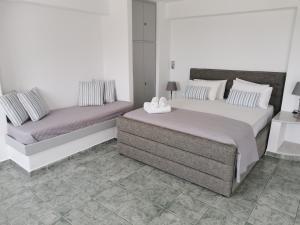 a bedroom with two beds and a tiled floor at WONDERFUL SEA VIEW in Parikia