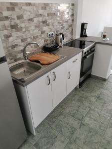 a kitchen with a sink and a stove at WONDERFUL SEA VIEW in Parikia +13 photos