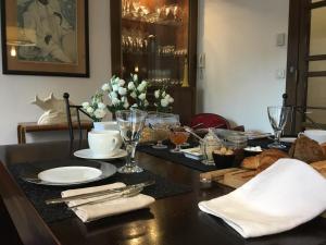 a dining room table with plates and dishes on it at Au Cœur De Lille in Lille