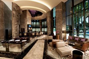 a lobby of a hotel with couches and tables at Carlton City Hotel Singapore in Singapore