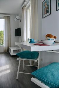 a dining room with a white table and chairs at Bellevue Bellavista Montagnola in Lugano