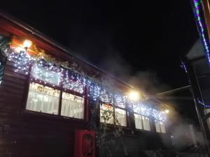 a building decorated with christmas lights at night at Casa Bazna in Bazna