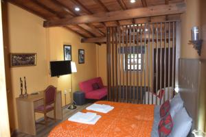 a bedroom with a bed and a desk and a couch at Quinta da Boa Ventura in Bragança