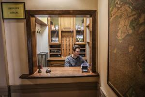 a man taking a picture of himself in a mirror at Hotel Kavalerie in Karlovy Vary