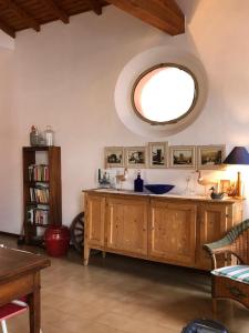 a living room with a large round mirror on the wall at Klimt's Mill overlooking Port in Malcesine